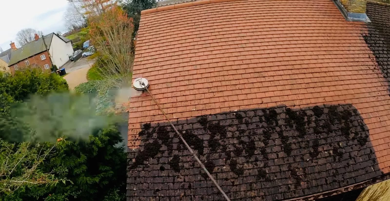Exterior roof cleaning service on a residential property