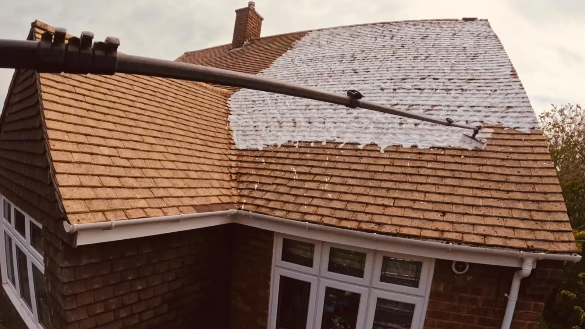 Soft wash foam treatment applied to roof tiles